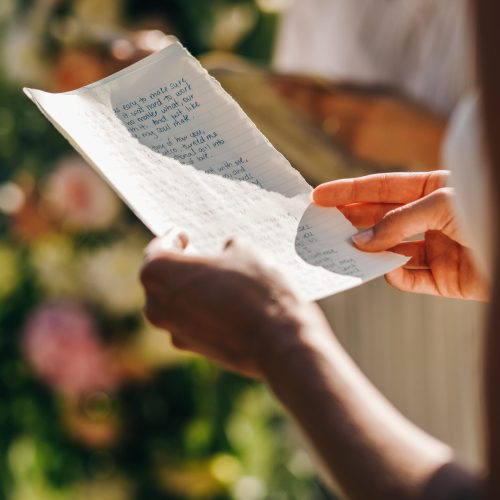 Wedding ceremony. Bride holds a paper with his oath